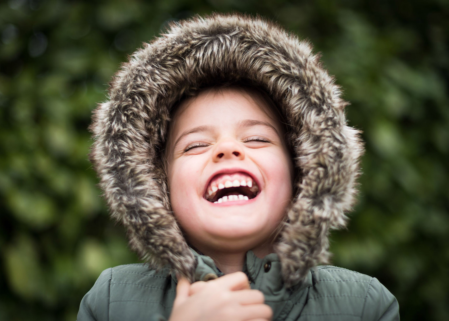 smiling little girl with her coat